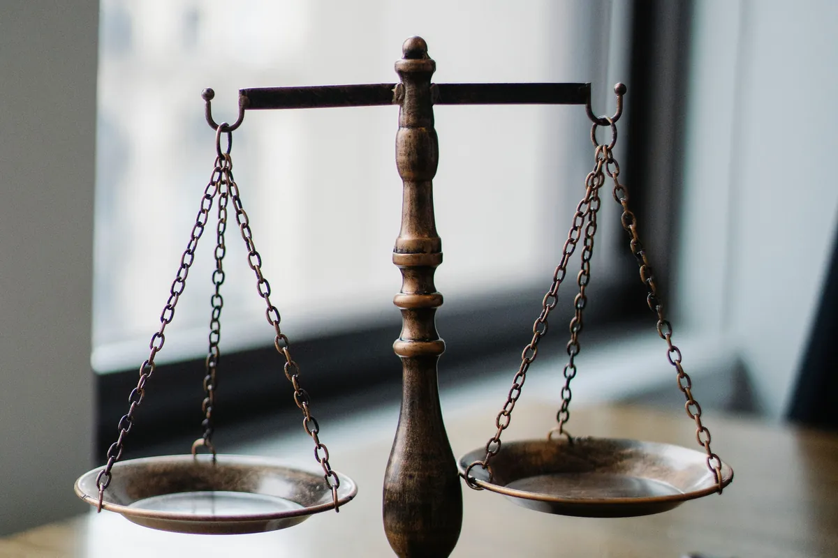 Scales of justice beside legal documents, representing intellectual property